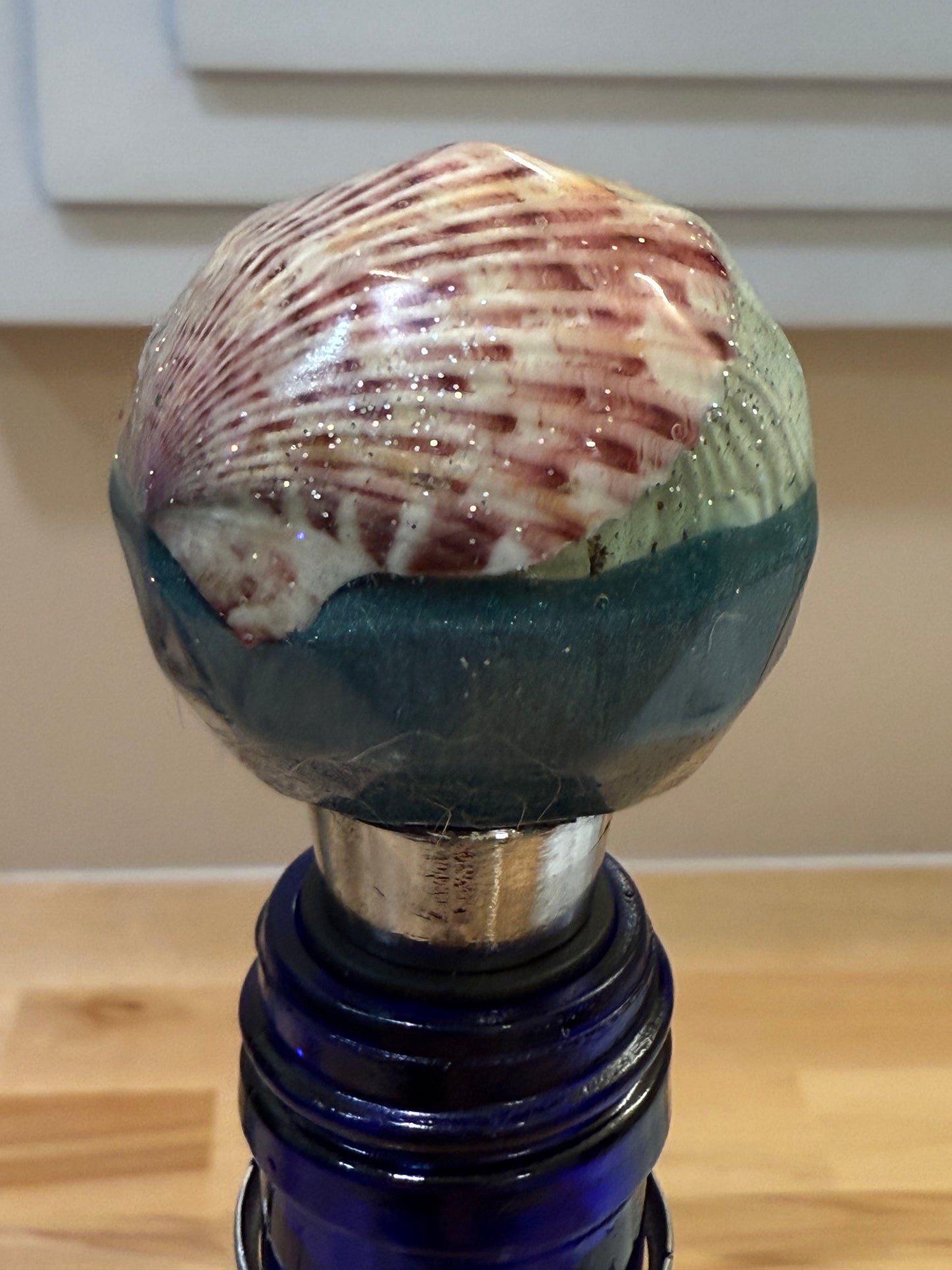 Round topped bottle stoppers made with resin filled with real shells
