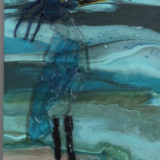 glass blue heron on a canvas painted as sunset