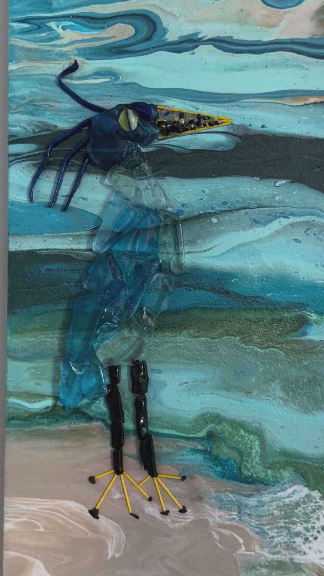 glass blue heron on a canvas painted as sunset